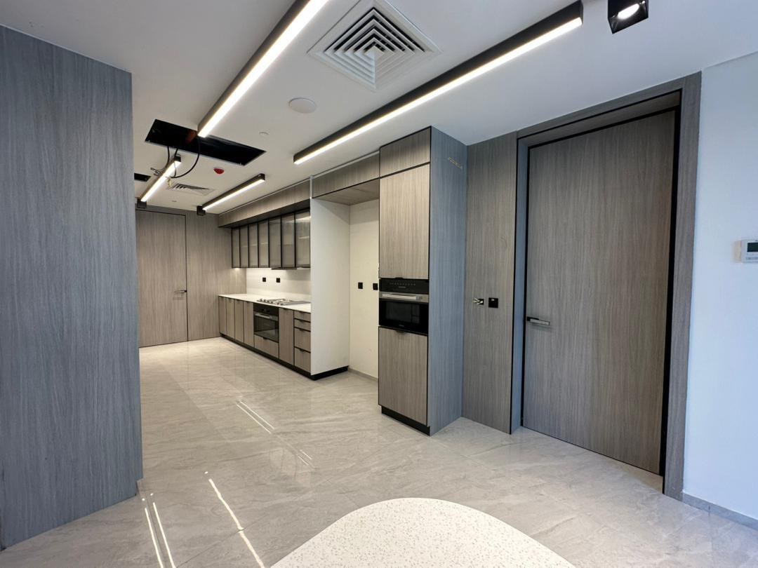 Kitchen seen from the dining end, full-height joinery either side